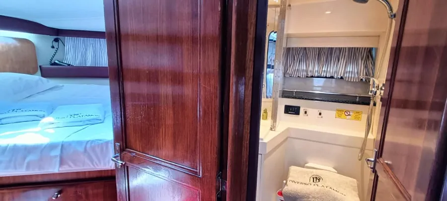 A cabin bed under the wood-trimmed hull side