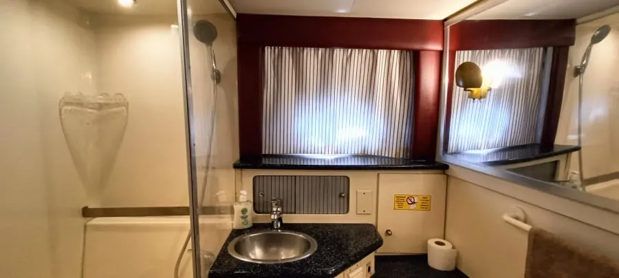 The ensuite bathroom, with its basin and porthole window